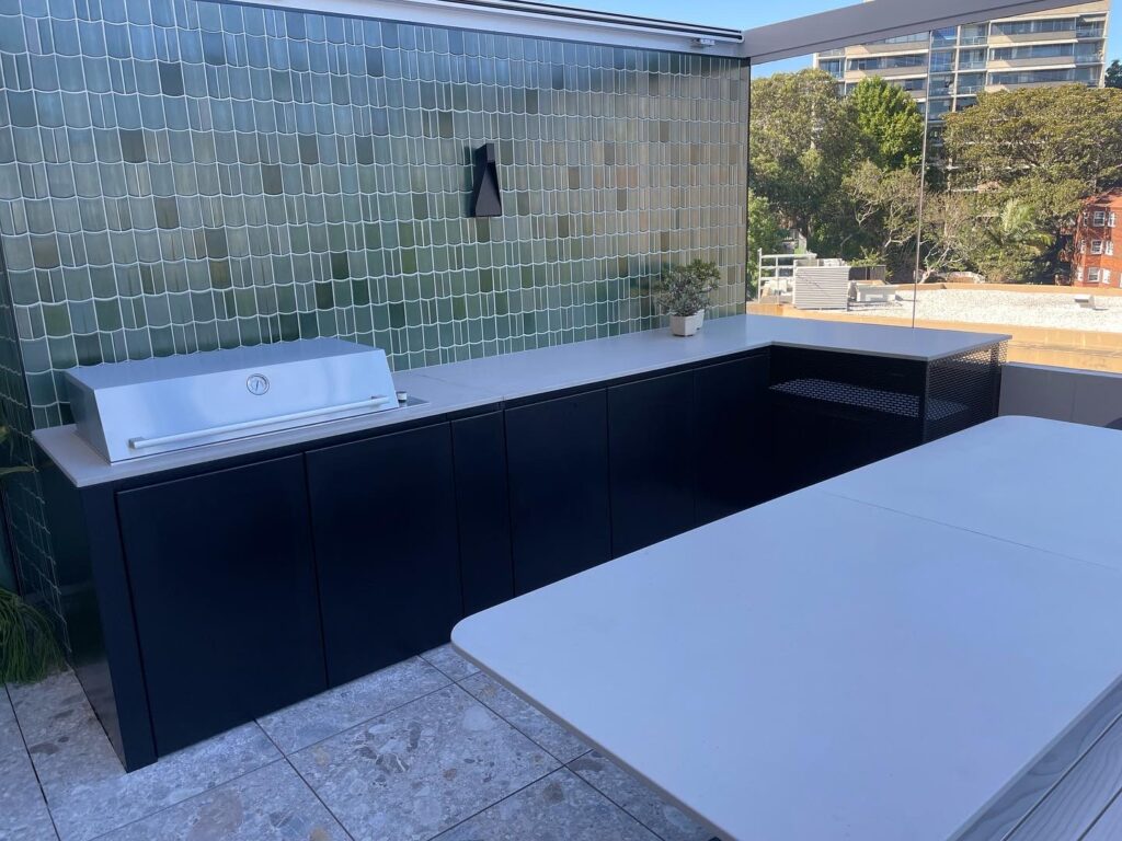 Architectural outdoor BBQ area with stainless steel benchtops and storage