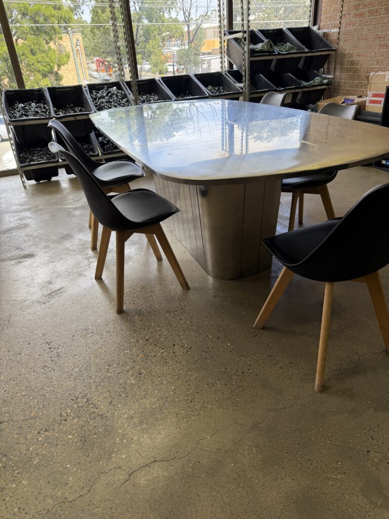 Stainless steel dining table with a clean, minimalist design