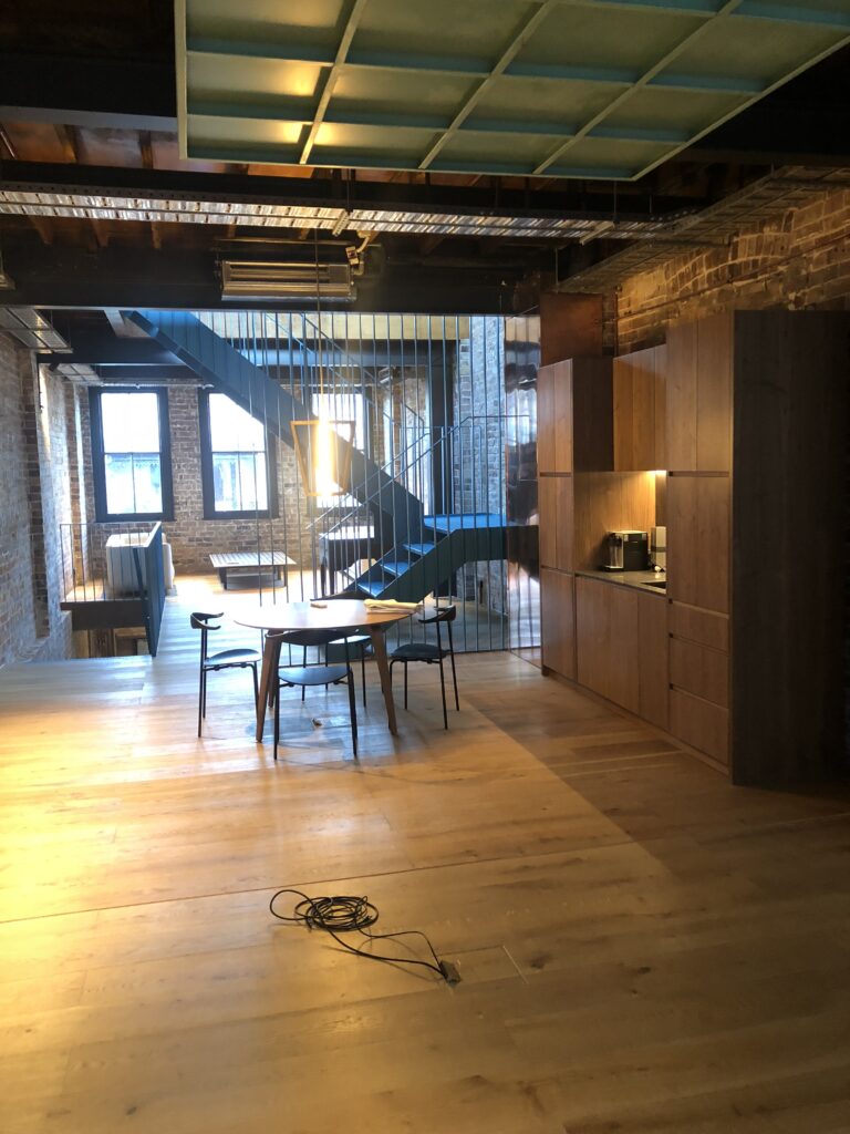 Architectural steel staircase with vertical safety balustrade and brick wall