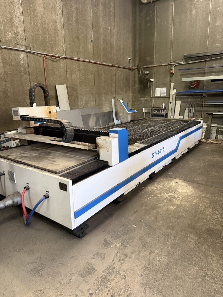 CNC laser cutting machine processing stainless steel sheet, showing precision cutting and maximum sheet size capacity in fabrication